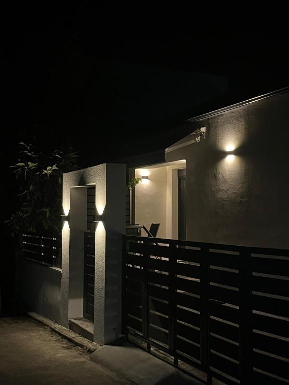 a house with lights on the side of it at night at Sofia's House in Nea Moudania