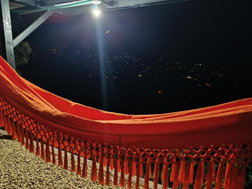 a red hammock sitting next to a body of water at cabaña in San Francisco