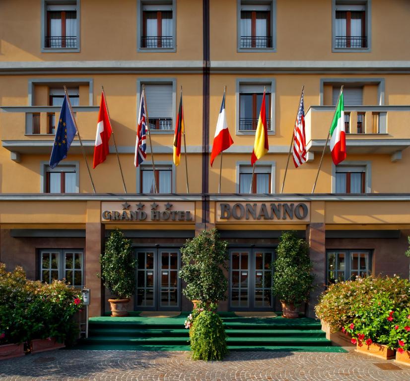 a hotel with flags on the front of it at Grand Hotel Bonanno in Pisa