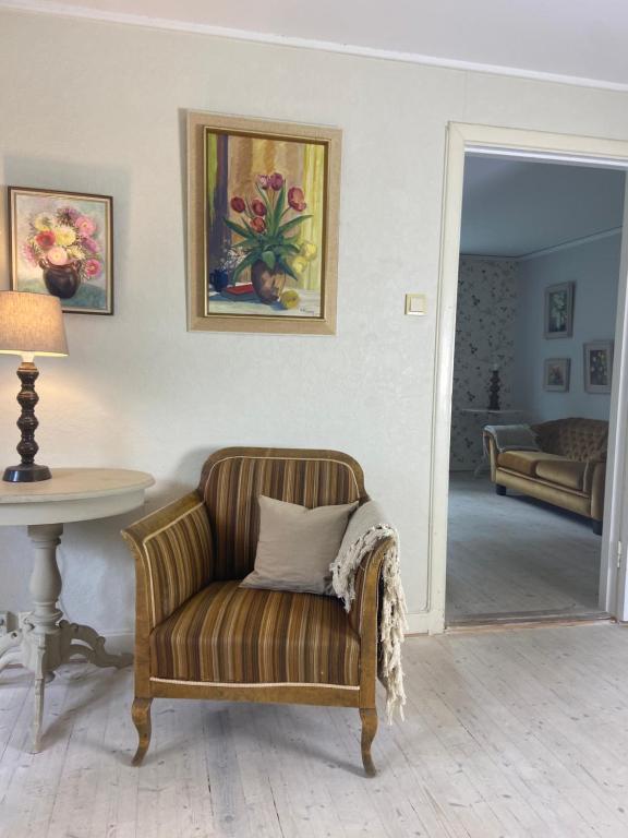 a living room with a chair and a table at Farm Stay B & B in Annerstad
