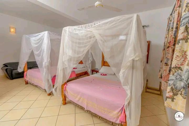 Postel nebo postele na pokoji v ubytování Mlima cottage