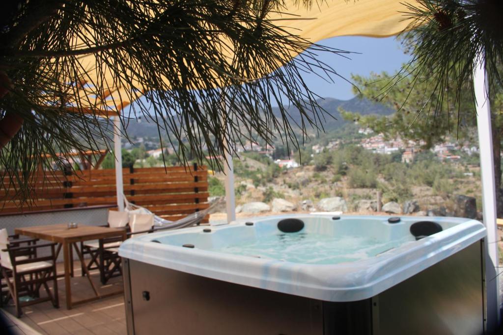 a jacuzzi tub on a patio with a view at Agros Glamping Boutique in Agros
