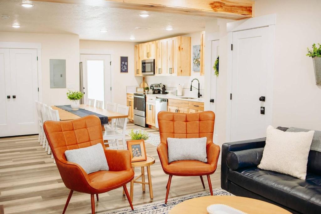 a living room with a couch and chairs and a kitchen at Creekside Cabins- Birch stylish stay w views in McCammon
