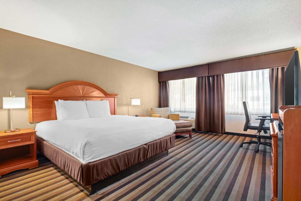 a hotel room with a bed and a desk at Best Western Rockland in Rockland