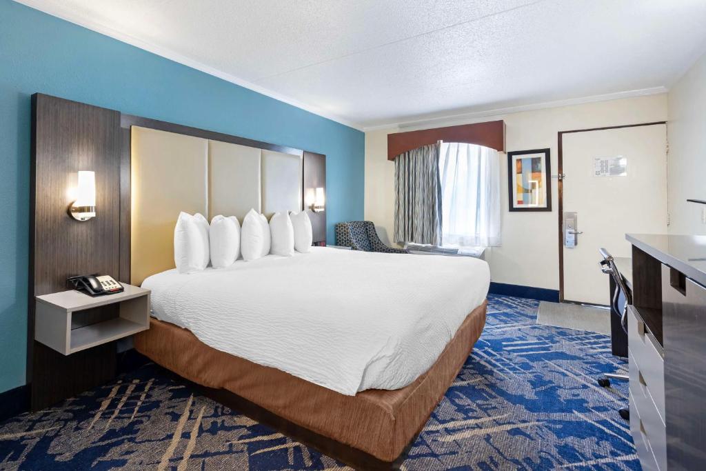 a hotel room with a large bed and a desk at Best Western Franklin in Franklin