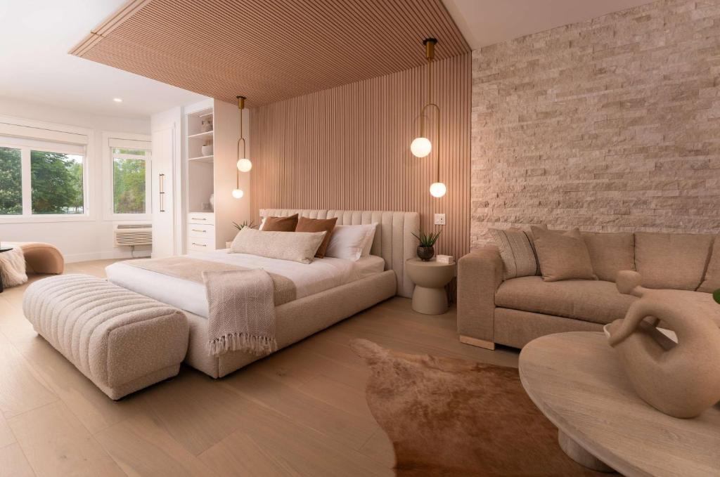 a bedroom with a bed and a couch at Prestige Beach House, WorldHotels Crafted in Kelowna
