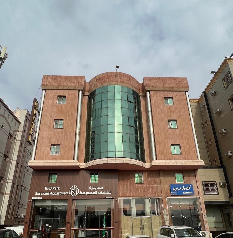 a building in a city with cars parked in front at رفد بارك in Abha