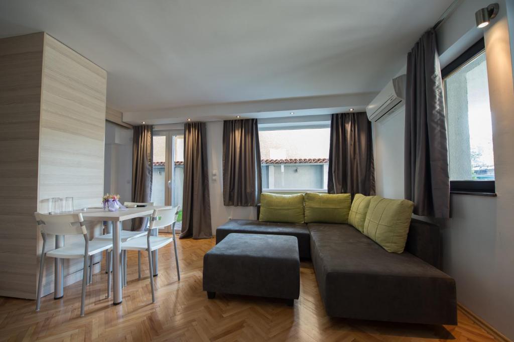 a living room with a couch and a table at Theatre Apartments in Bitola