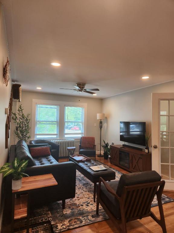 a living room with a couch and a tv at Backyard Bliss in the White Mountains in Lincoln