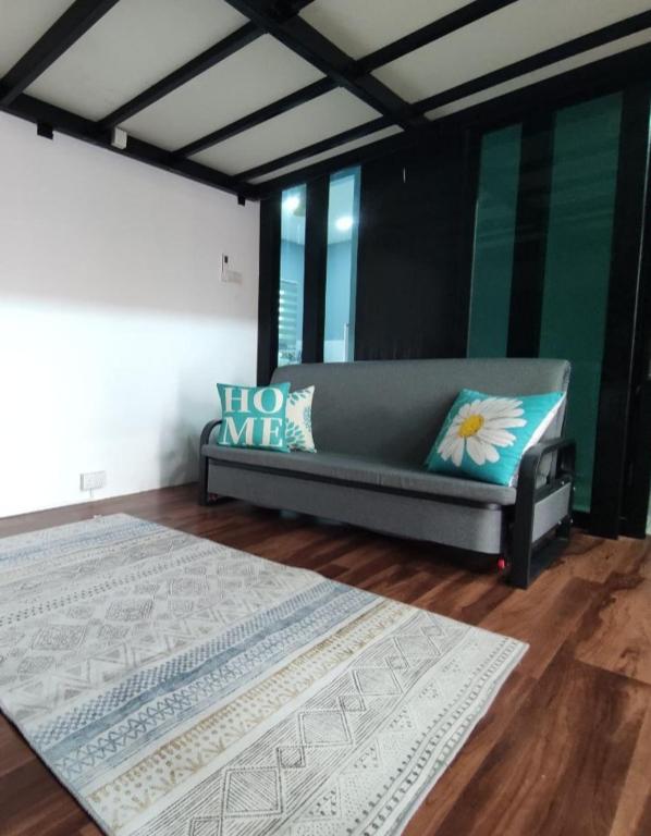 a living room with a couch and a rug at Maileyna Homestay 2 in Kampong Alor Merah