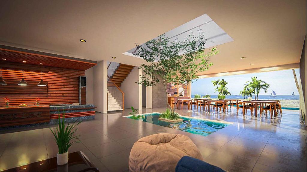 a living room with a table and chairs and the ocean at Beach Castle Arugam Bay in Arugam Bay