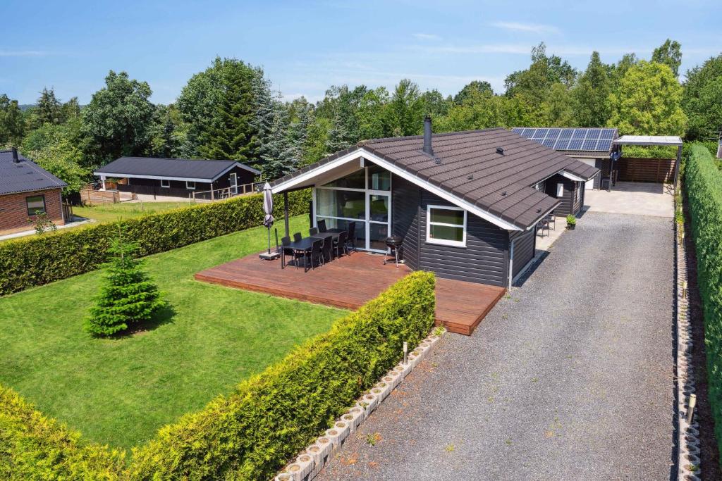a small house with a porch and a yard at Luxury House Spasauna, Carcharger, River in Fårvang