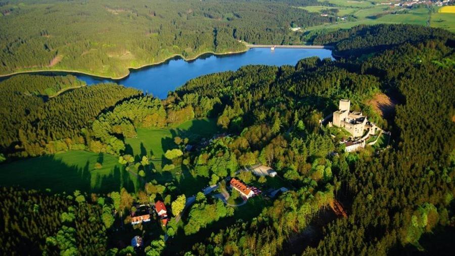 an aerial view of a house and a lake at Apartmány pod Landštejnem in Staré Město