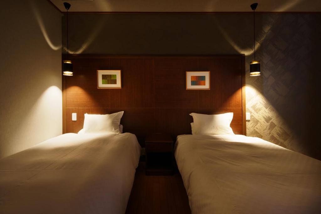 Postel nebo postele na pokoji v ubytování Kintarou Onsen Hotel