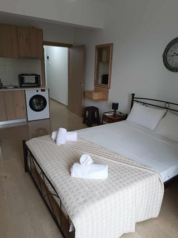 a bedroom with a large bed with towels on it at Ascension Corfu Studios by GuestCorfu in Análipsis