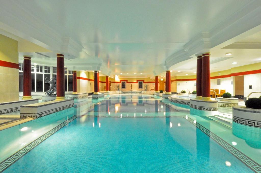 a large swimming pool in a large building at The Ardilaun Hotel in Galway