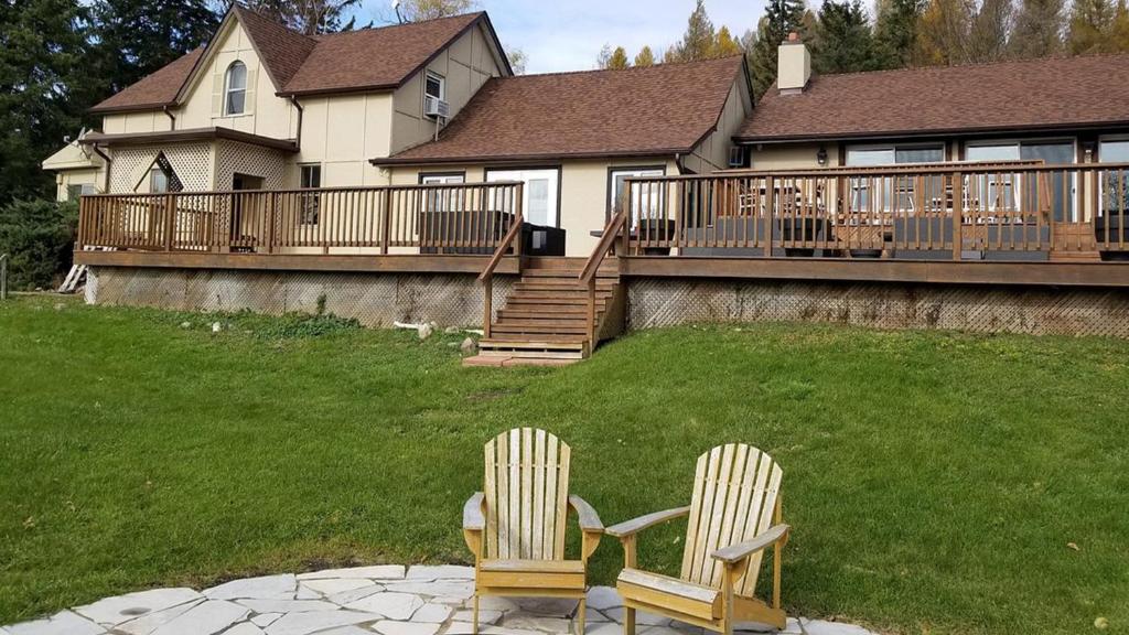 two chairs sitting on a patio in front of a house at Northumberland Heights Wellness Retreat & Spa in Cobourg