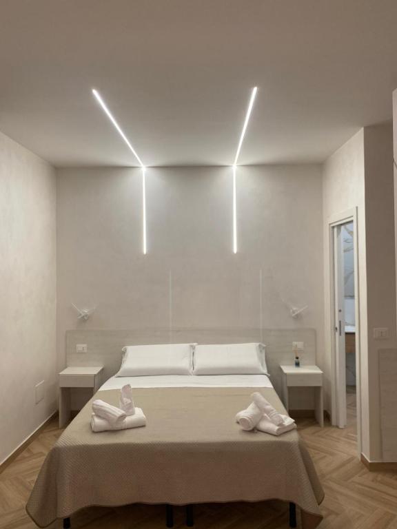 a bedroom with a bed with two towels on it at B&B Villa Soleil in Vibo Valentia