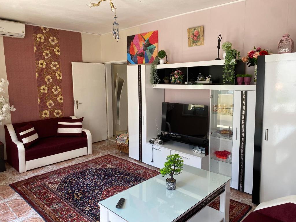 a living room with a couch and a tv at Centrum in Burgas City