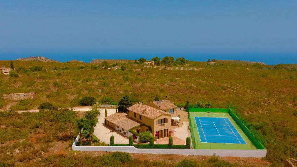 an aerial view of a house with a tennis court at Secrets Rural House in Jávea