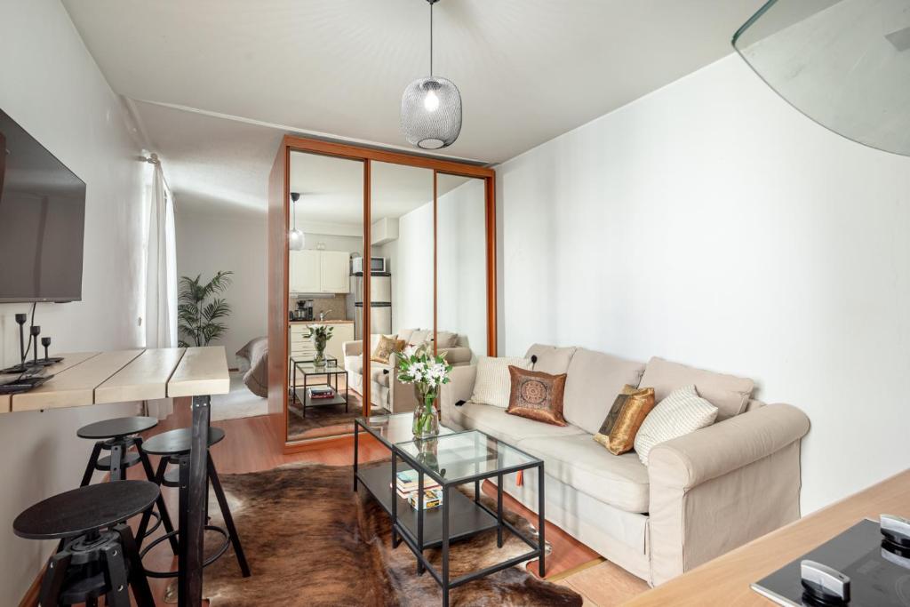 una sala de estar con un sofá y una mesa en New flat, best location Helsinki, en Helsinki