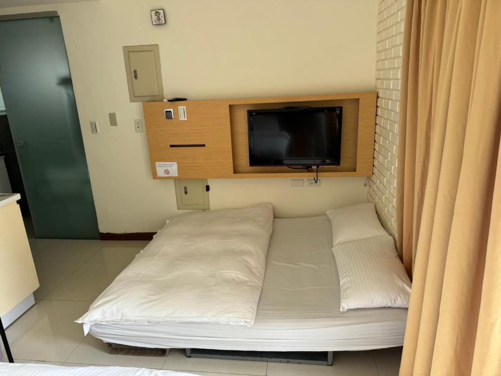 Postel nebo postele na pokoji v ubytování Tianmu Star Urban Living