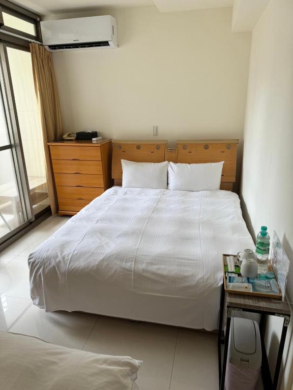 Postel nebo postele na pokoji v ubytování Tianmu Star Urban Living
