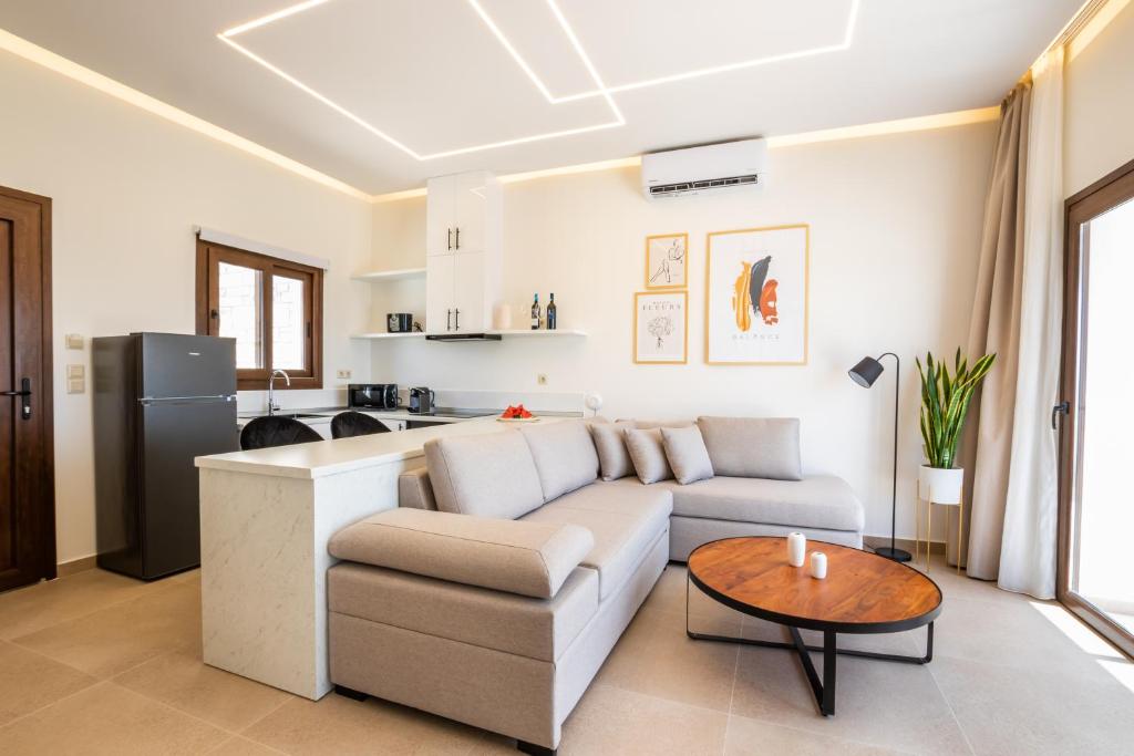 a living room with a couch and a table at Elite Luxury Villas in Afiartis