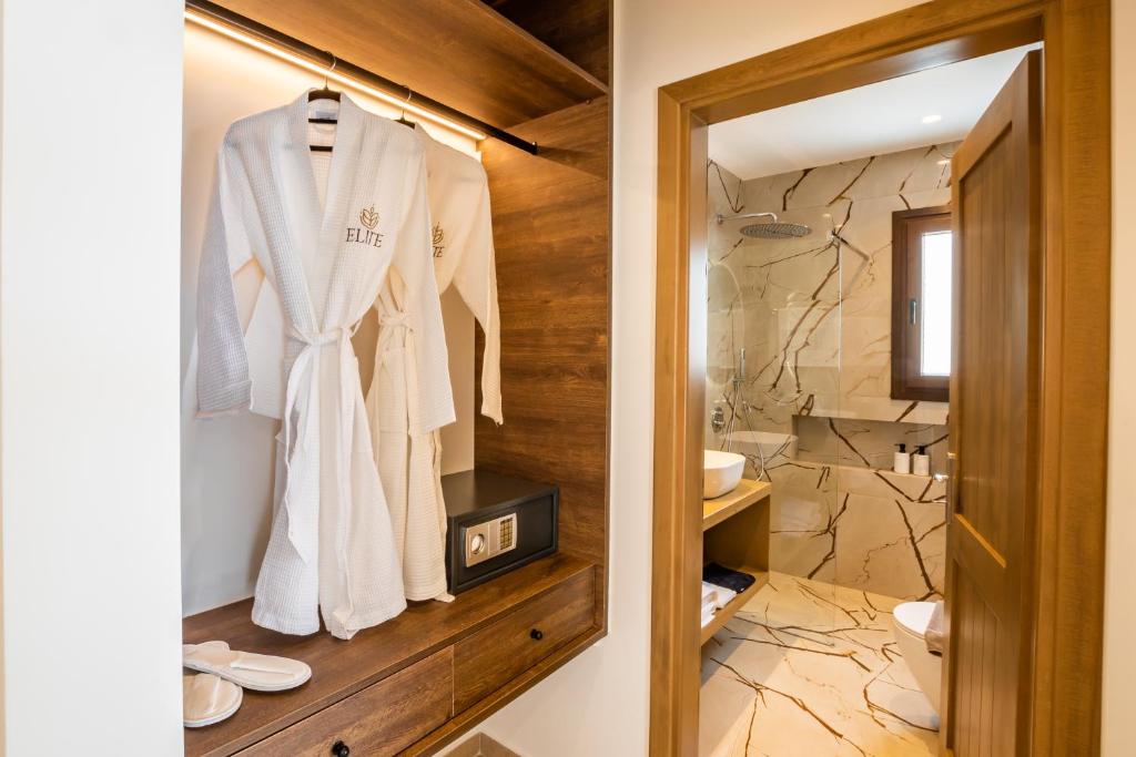 a bathroom with a shower and a robe on a rack at Elite Luxury Villas in Afiartis