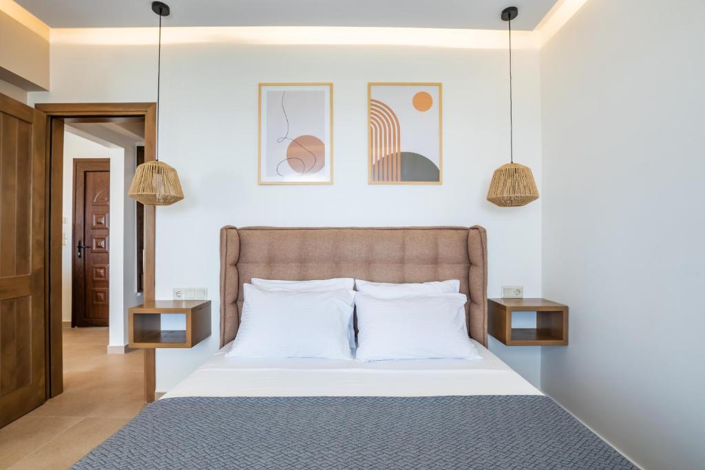 a bedroom with a bed with two night stands at Elite Luxury Villas in Afiartis