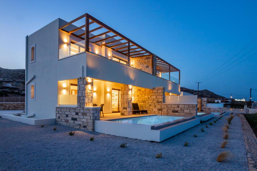 a house with a swimming pool in front of it at Elite Luxury Villas in Afiartis