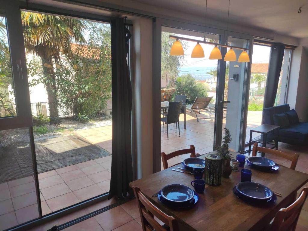 a dining room table with blue dishes on it at Appartement Balthasar - Turm Krk in Sveti Vid-Miholjice