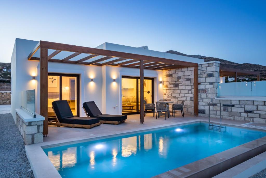 a house with a swimming pool and a patio at Elite Luxury Villas in Afiartis