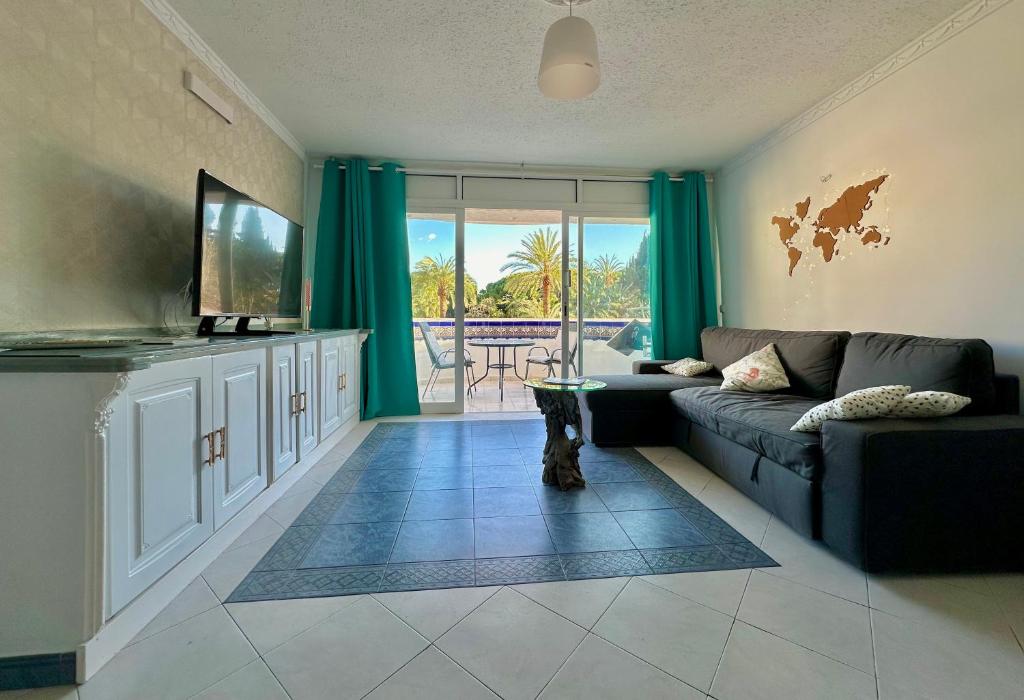 salon z kanapą i telewizorem w obiekcie Marbesa Marbella Apartment w Marbelli