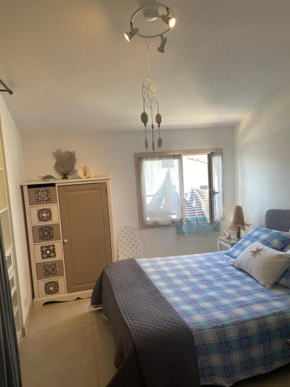 a bedroom with a bed and a window at Saint-Cyprien Appartement de standing in Saint-Cyprien