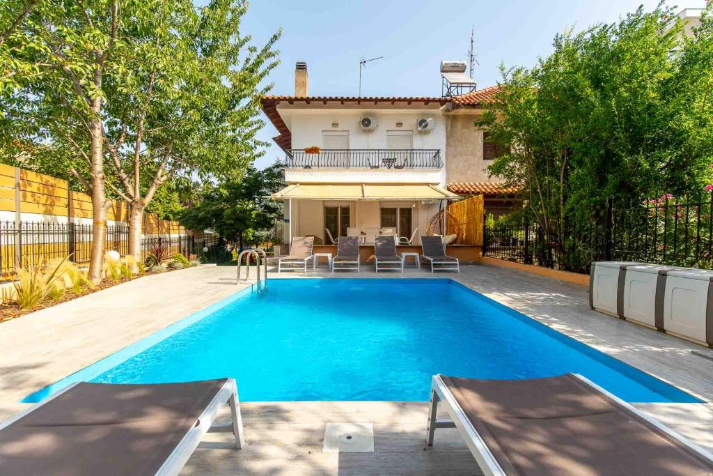 a swimming pool in the backyard of a house at Heated Pool Villa in Thessaloniki - Urban Oasis in Thessaloniki