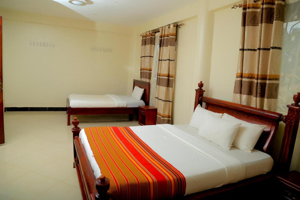 Postel nebo postele na pokoji v ubytování Acactus Hotel