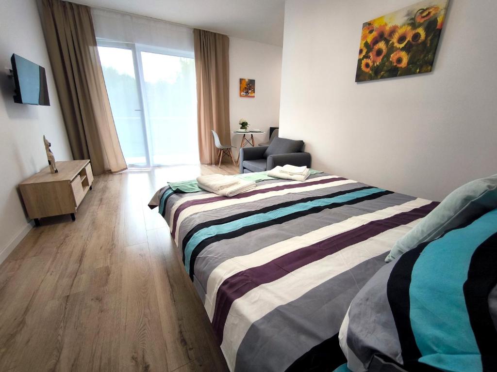 Postel nebo postele na pokoji v ubytování Apartmány Karpatia s privátnym parkovaním