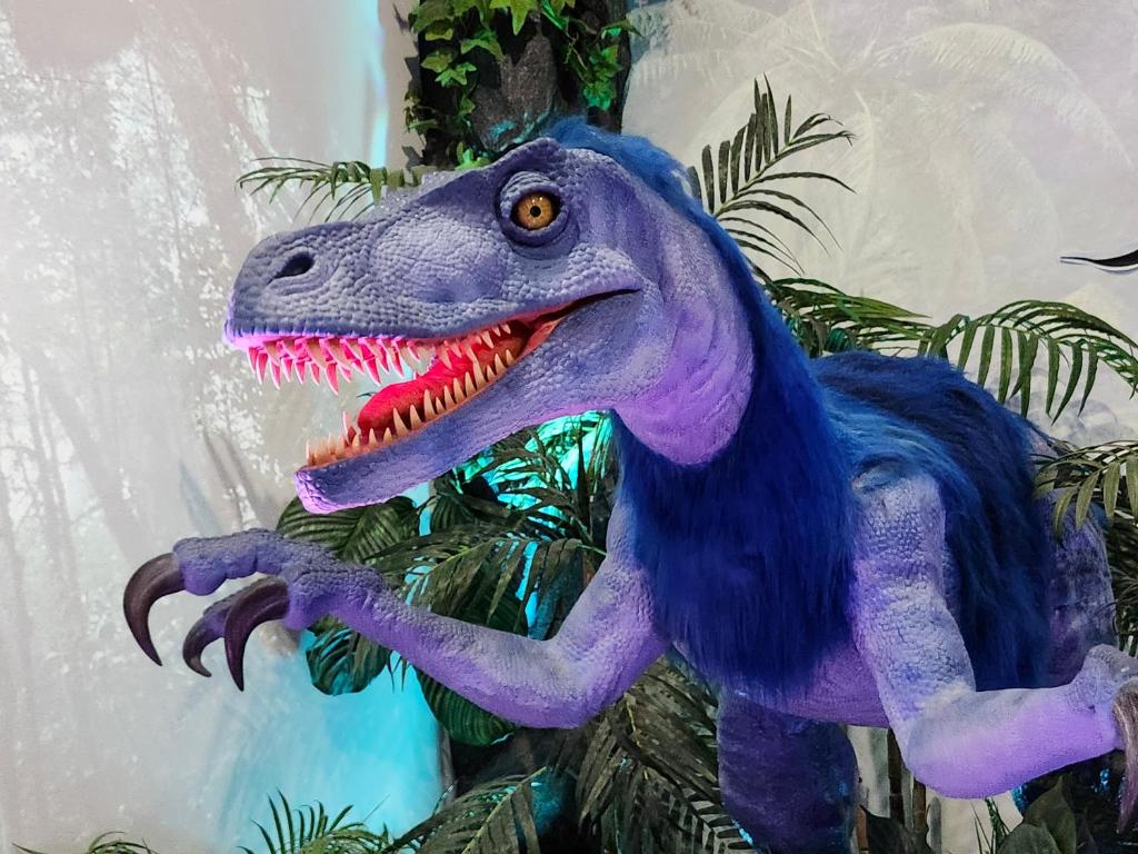 a purple dinosaur toy is hanging on a plant at Henn na Hotel Fukuoka Hakata in Fukuoka