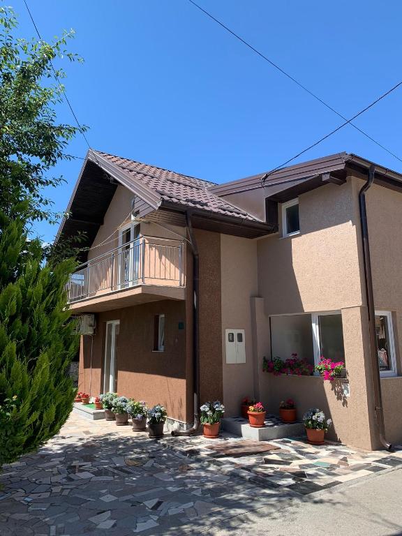 a house with potted plants in front of it at Home DINA in Ilidža