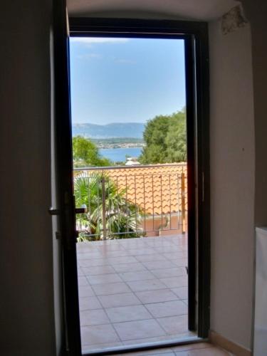 an open door with a view of a patio at Appartement Caspar- Turm Krk in Sveti Vid-Miholjice