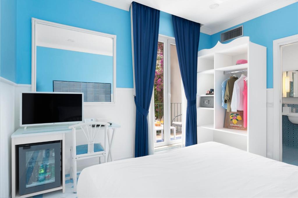 Postel nebo postele na pokoji v ubytování Hotel Bougainville