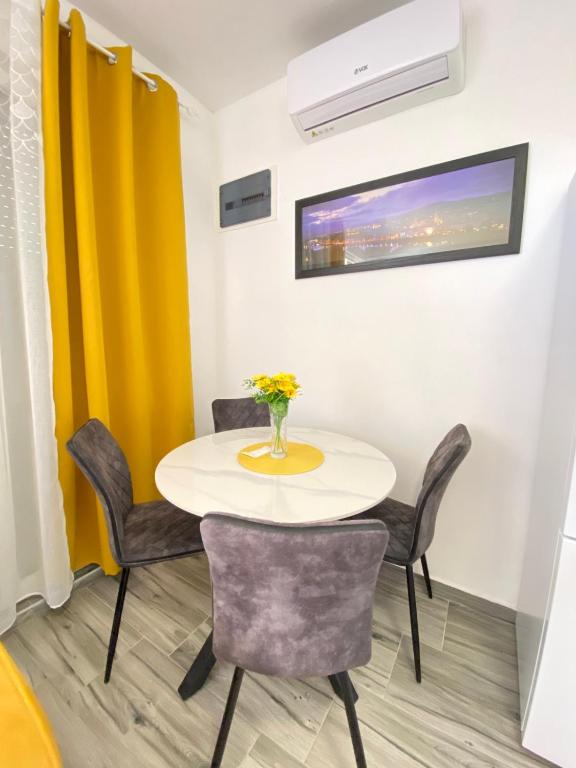 a dining room with a table and chairs at OLGA APARTMENT in Kotor