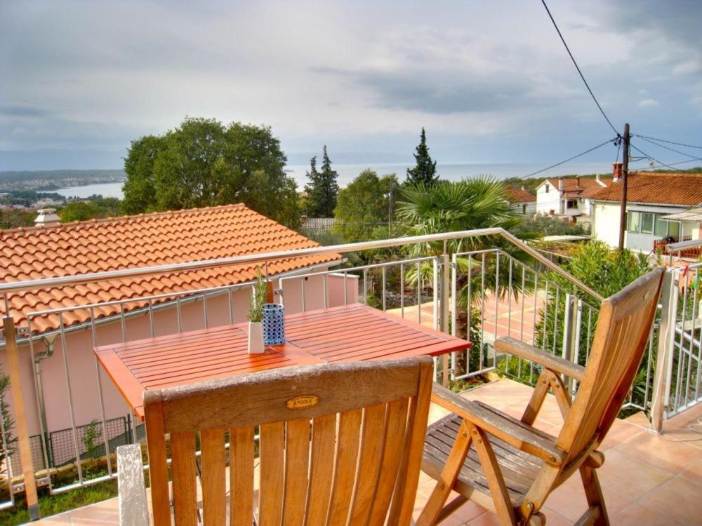 a table and two chairs on a balcony at Appartement Melchior - Turm Krk in Sveti Vid-Miholjice