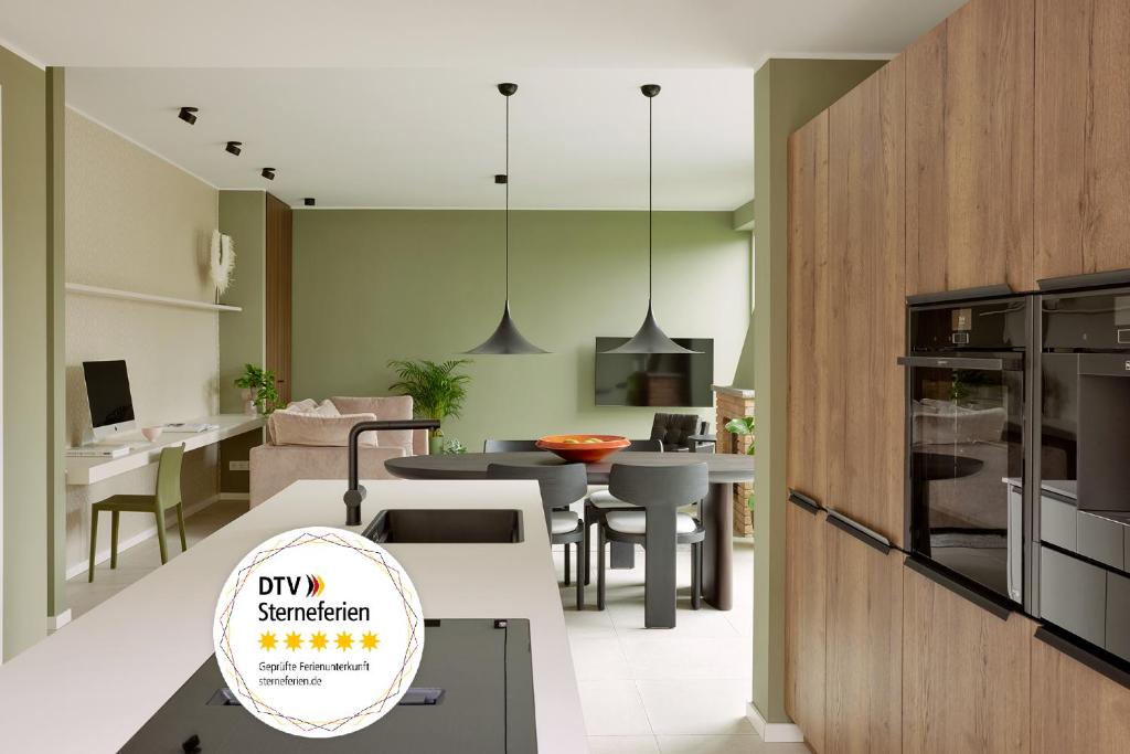 a kitchen and living room with a dining room at HOMEFY - Luxury Bungalow in Ratingen
