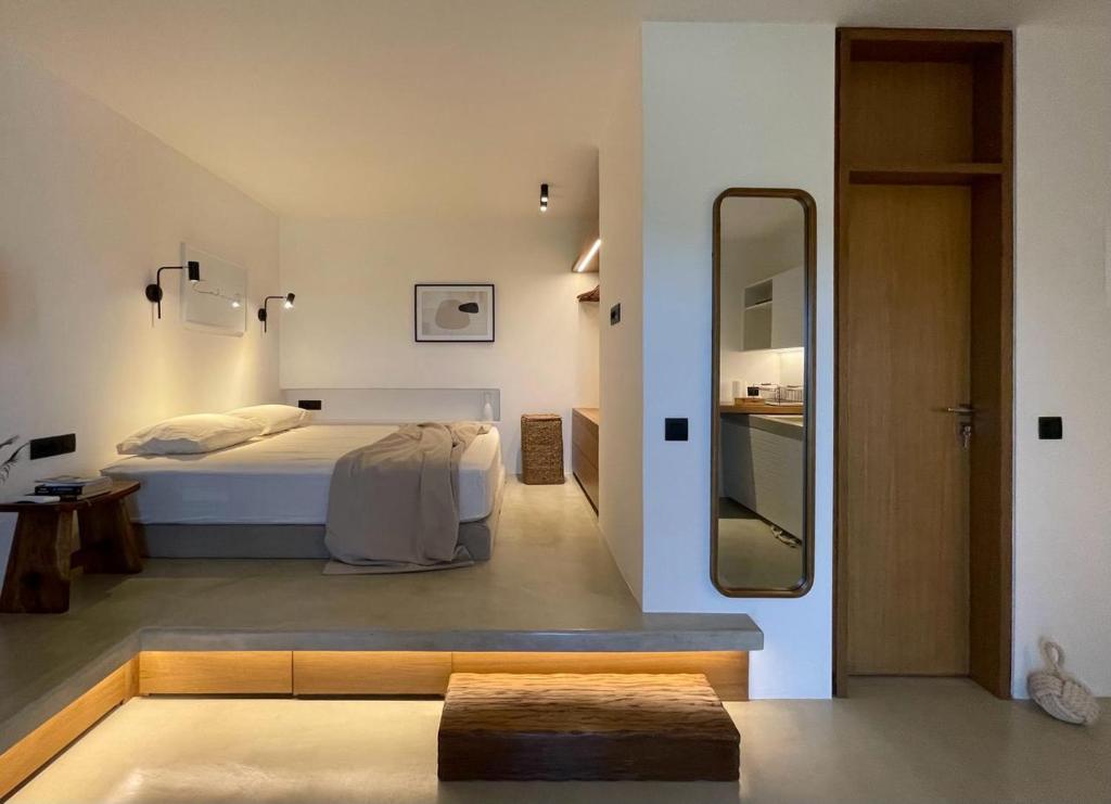 a bedroom with a bed and a large mirror at Hideaway Syros in Megas Gialos - Nites