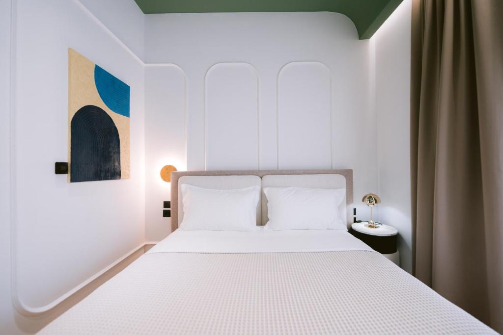 Postel nebo postele na pokoji v ubytování Noemie Hotel