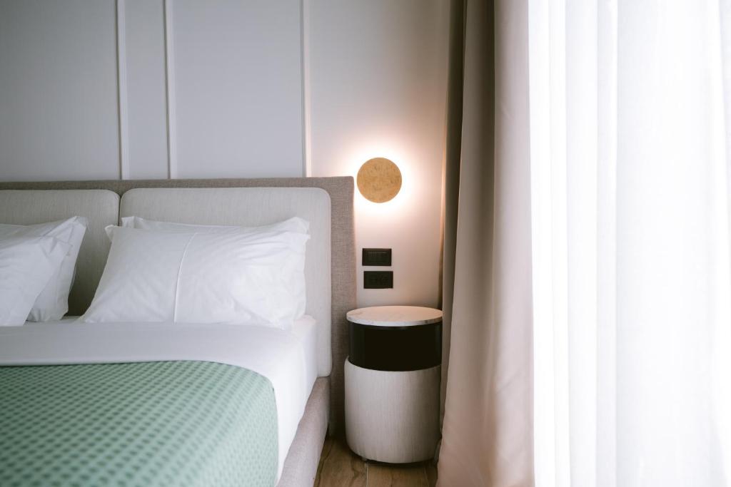 Postel nebo postele na pokoji v ubytování Noemie Hotel