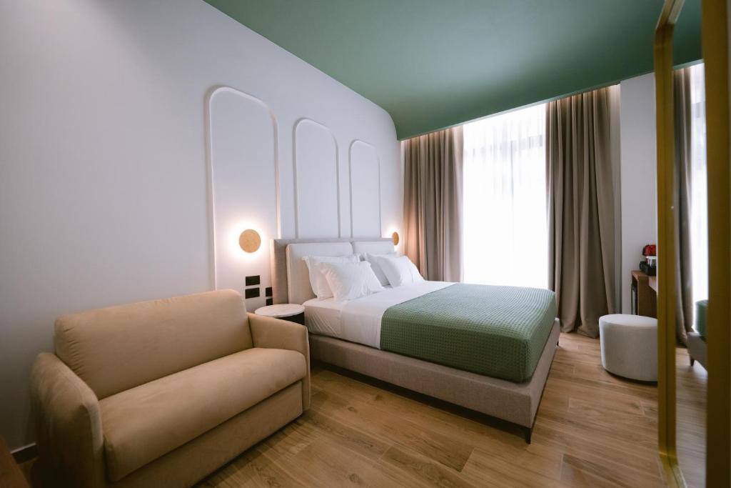 Postel nebo postele na pokoji v ubytování Noemie Hotel