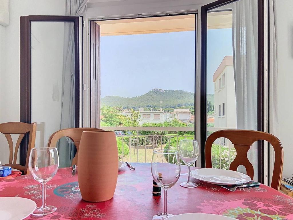 - une table avec des verres à vin et une vue dans l'établissement Élégant T3 Climatisé à Saint-Cyr-sur-Mer, Proche Plage des Lecques, Terrasse et Parking - FR-1-770-10, à Saint-Cyr-sur-Mer